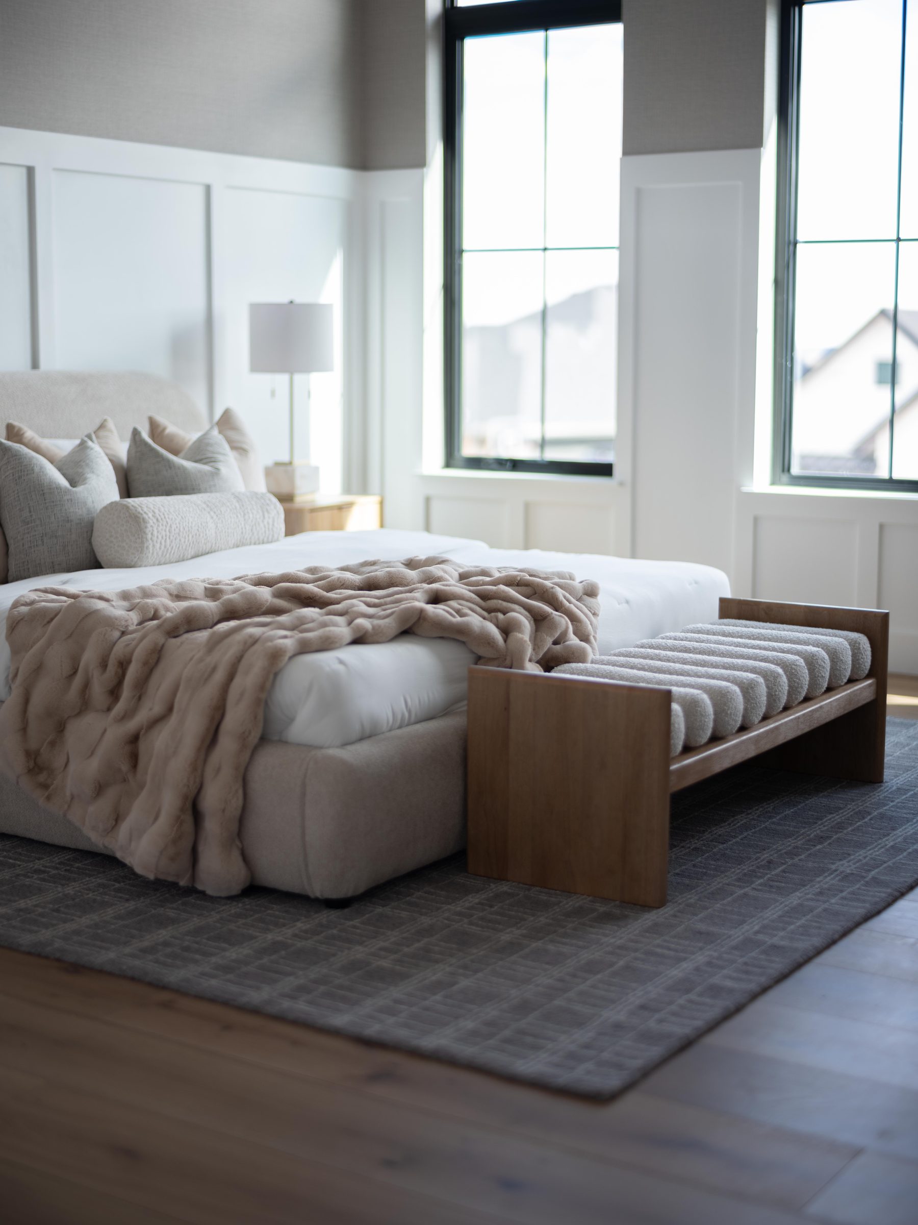 Bedroom with a textured throw and an end-of-bed bench