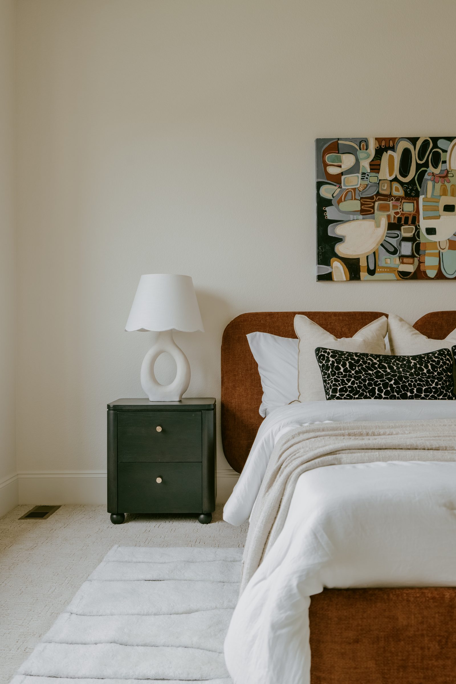 Primary bedroom with a warm wood bed